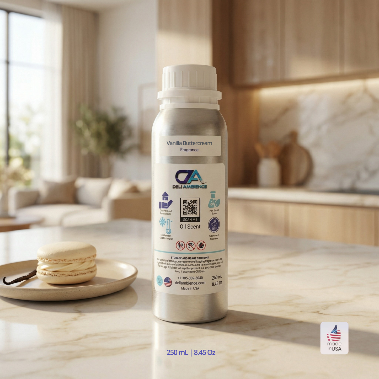 A silver bottle labeled "Vanilla Buttercream Oil Scent" sits on a marble kitchen counter beside two macarons, evoking a rich vanilla aroma. Kitchen cabinets and decor appear in the background.