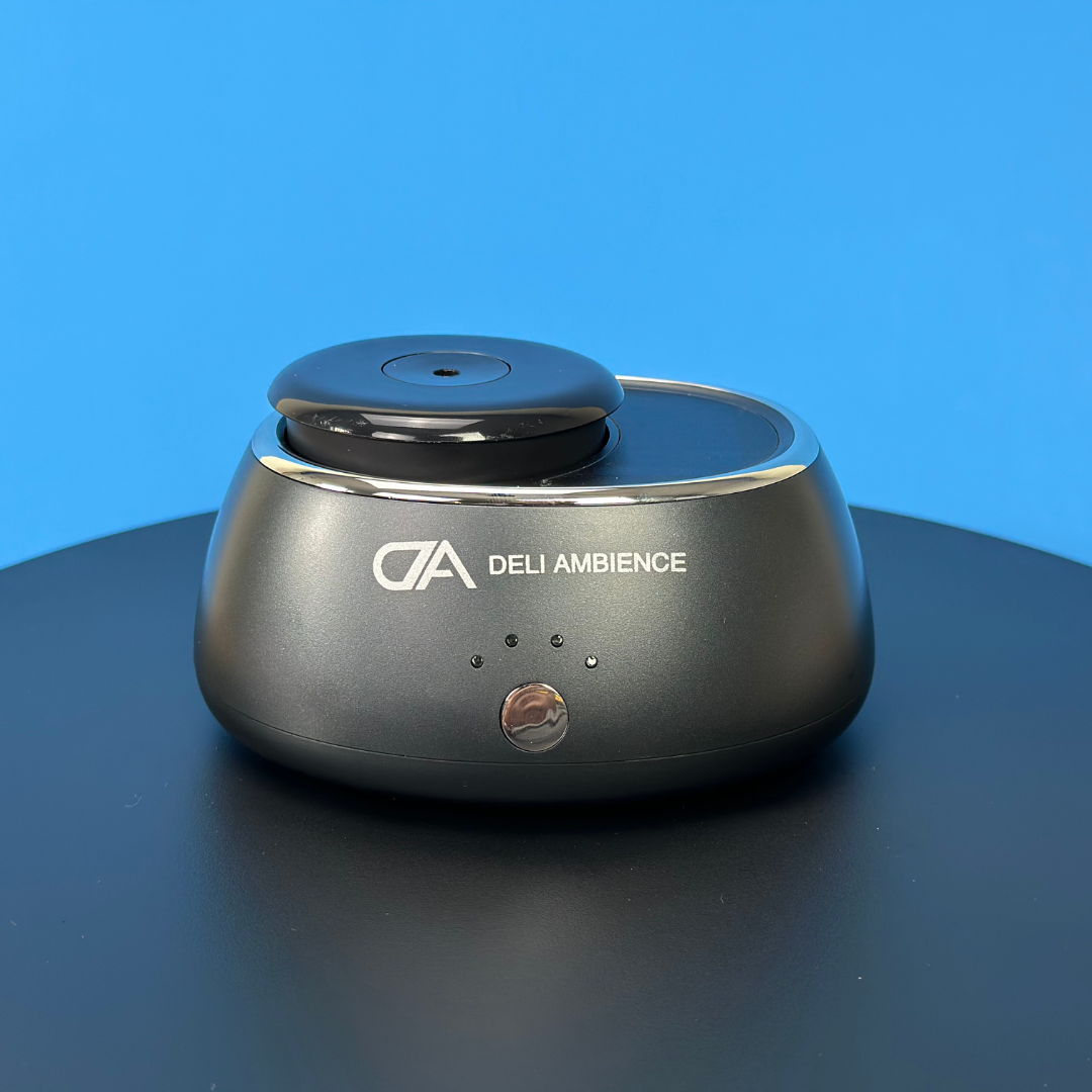 A DA Portable Scent Diffuser, a portable black device with the word "ad" on it, powered by solar energy, is used for diffusing fragrance.