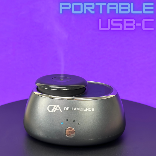 A DA Portable Scent Diffuser with fragrance on a table.