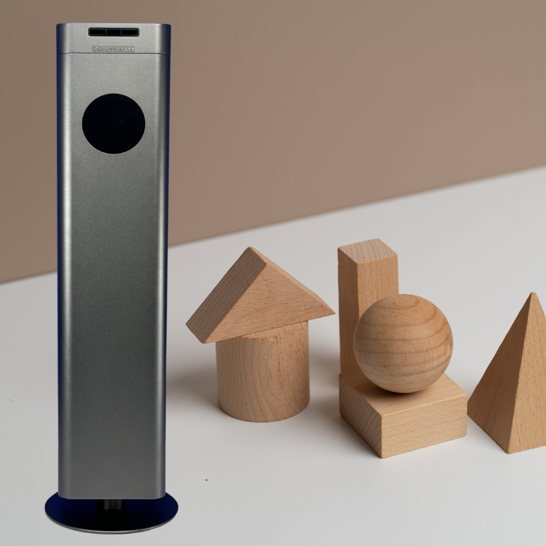 A DA Tower 1500 sits next to a set of wooden blocks, emitting soothing scents through its built-in fragrance oil diffuser. Utilizing cold diffusion technology, the DA Tower 1500 fills the room with delightful