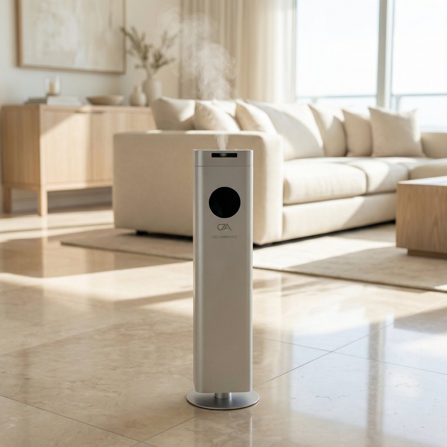 The DA Tower 1500, a sleek scent tower with cold diffusion technology, emits mist and elegantly fragrances your minimalist living room with beige furniture and large windows.