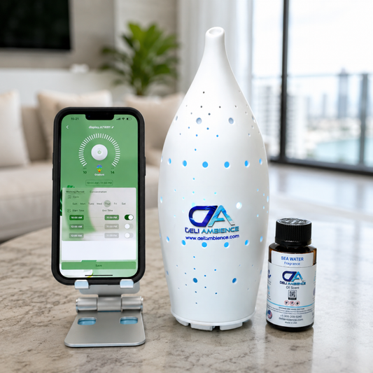A smartphone on a stand displays an app beside a white Starlight Kit Scent Diffuser and a small bottle labeled “Sea Water,” all arranged on a table in a modern living room. The Starlight Kit Scent Diffuser uses cold-air diffusion technology to gently fragrance the space while seamlessly complementing contemporary decor.
