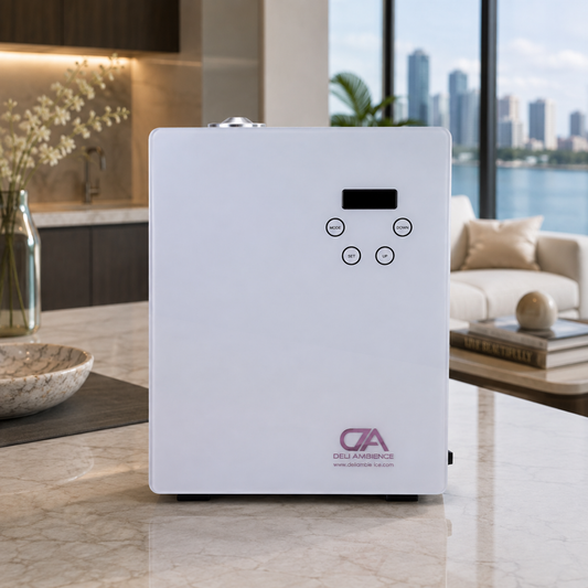 A white rectangular Triton Scent Diffuser with a small digital display and buttons sits on a marble countertop in a modern apartment with a city view.