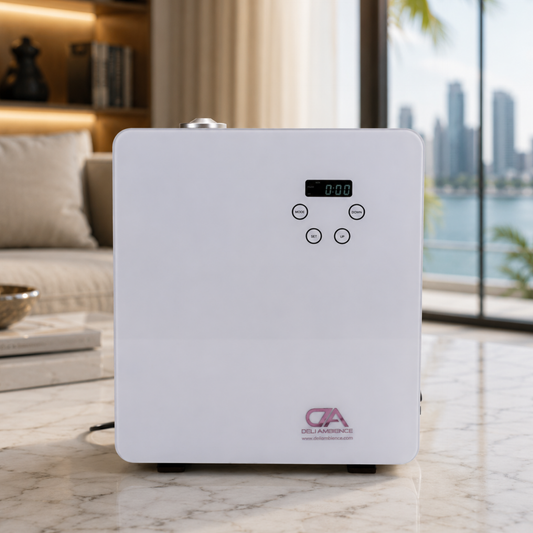 A Heracles Scent Oil Diffuser HVAC in white, featuring a digital display and five buttons, sits on a marble table in a modern room. It offers adjustable fragrance intensity and long-lasting scent, with city buildings visible through the window.